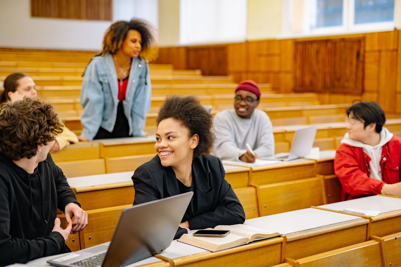 University students working on laptops during a lab in a lecture hall